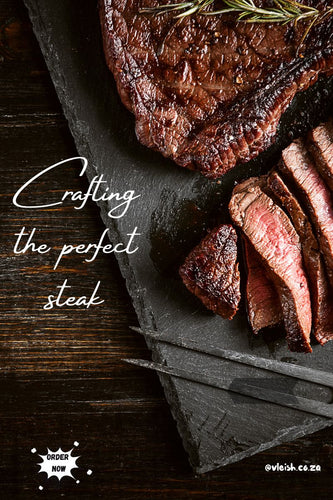 Steak cut into slices on top of a slate and wooden table.